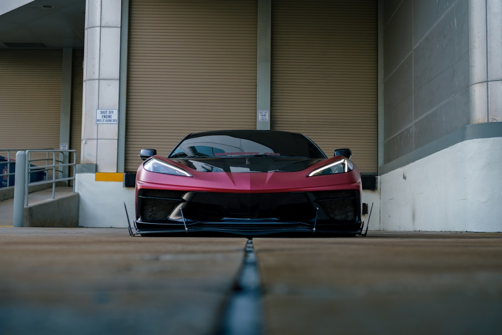 a red sports car parked in front of a building