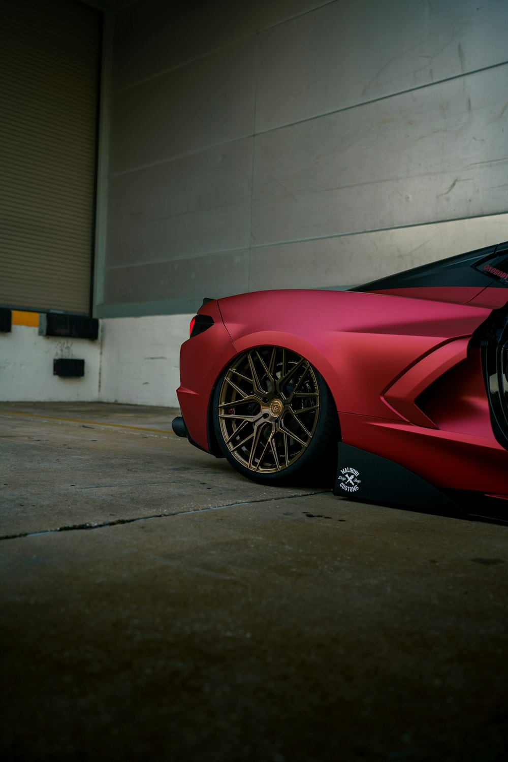 a red sports car parked in a garage