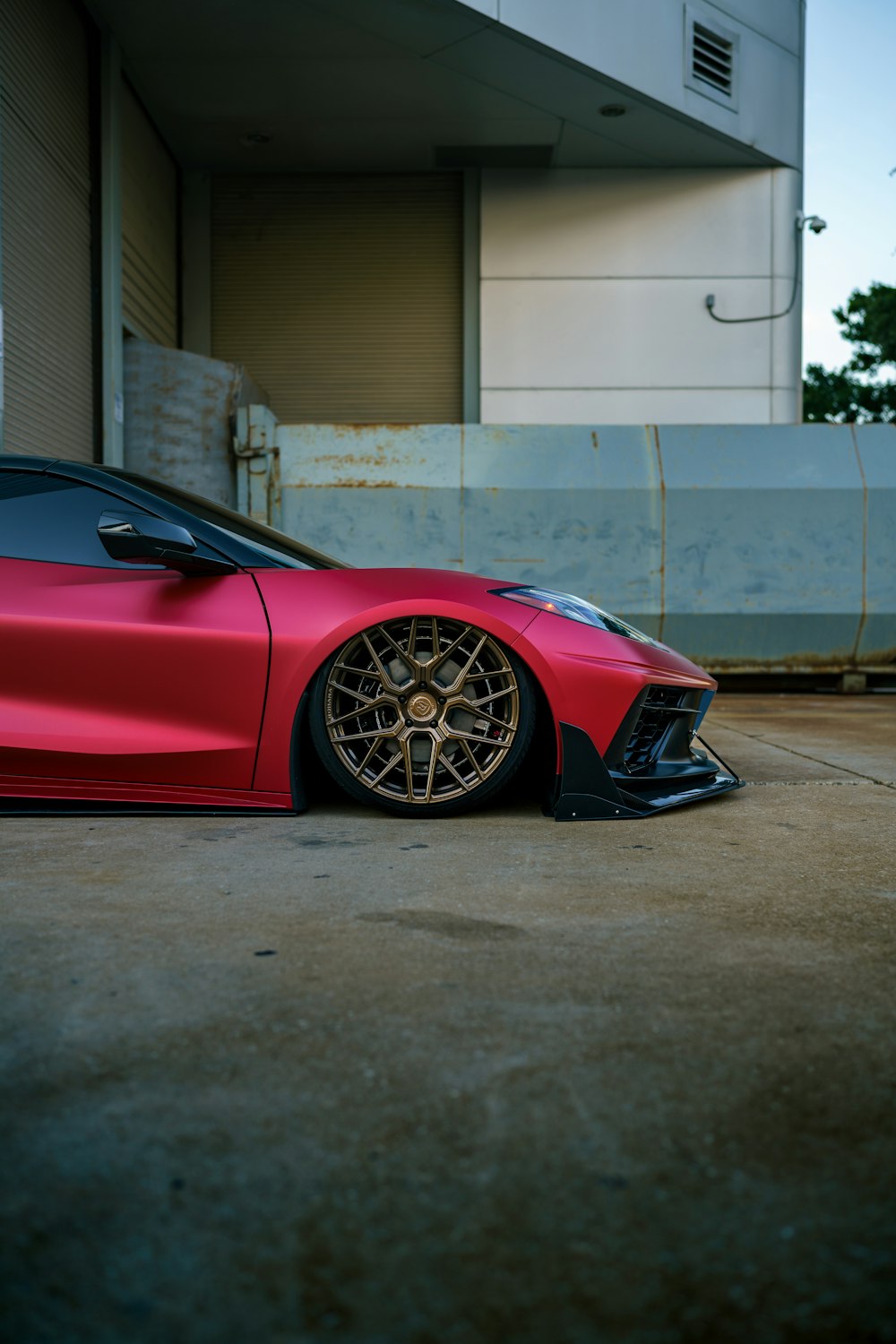 a red sports car parked in front of a building