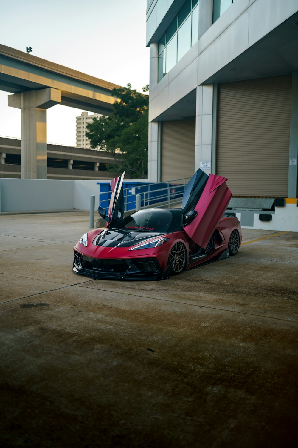 a red sports car parked in front of a building