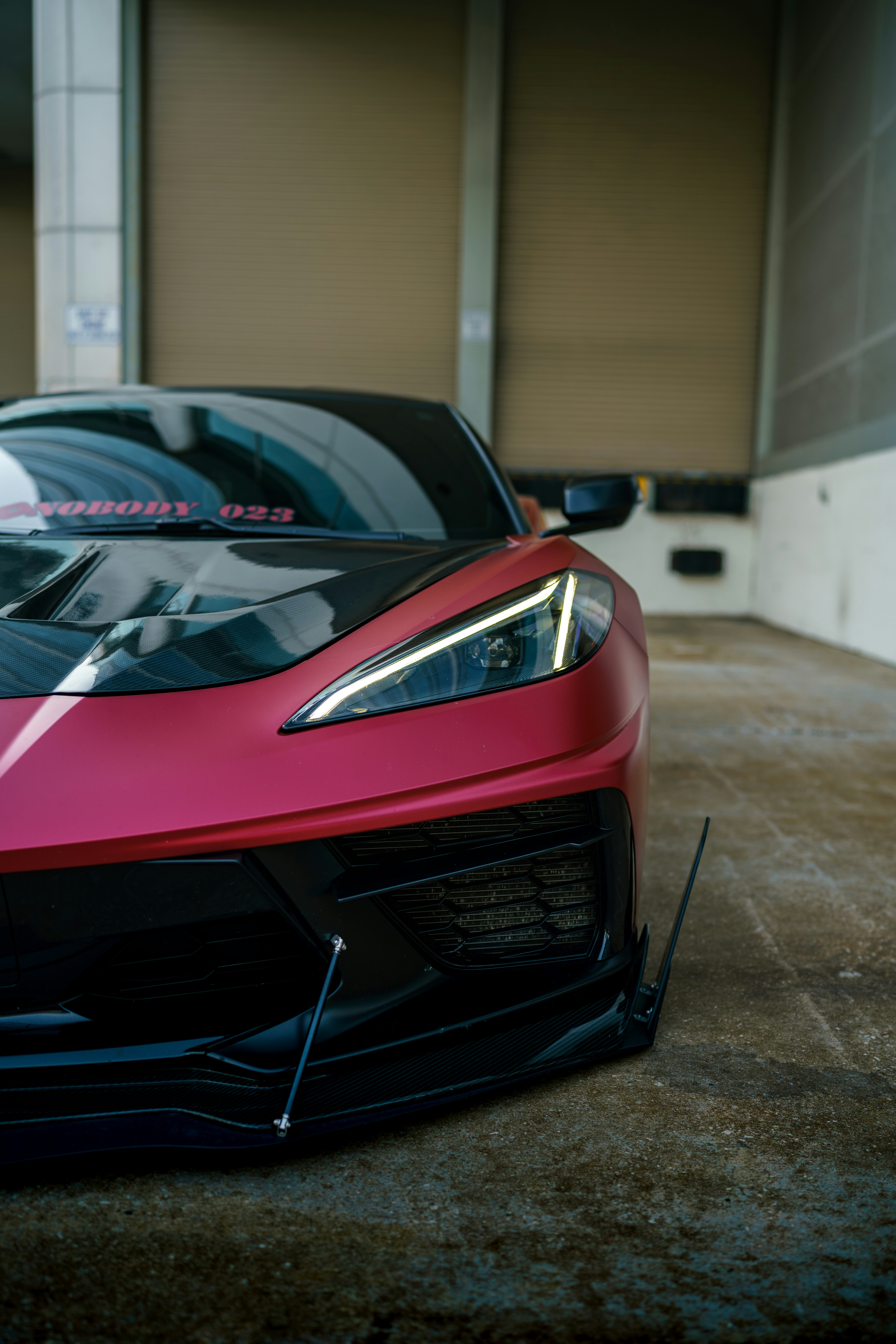a red sports car parked in a garage