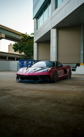 a red sports car parked in front of a building