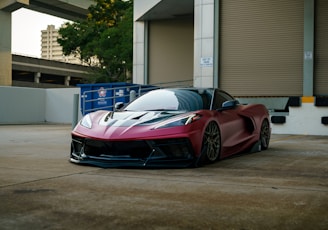 a red sports car parked in front of a building