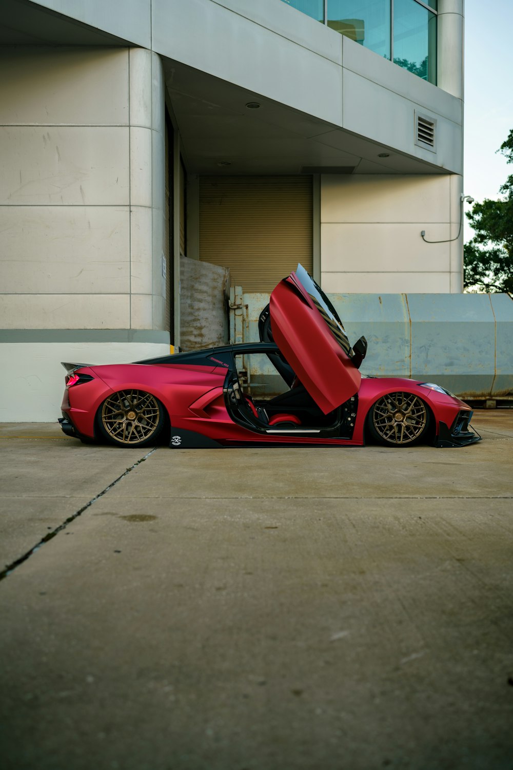 a red sports car parked in front of a building