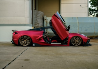 a red sports car parked in front of a building