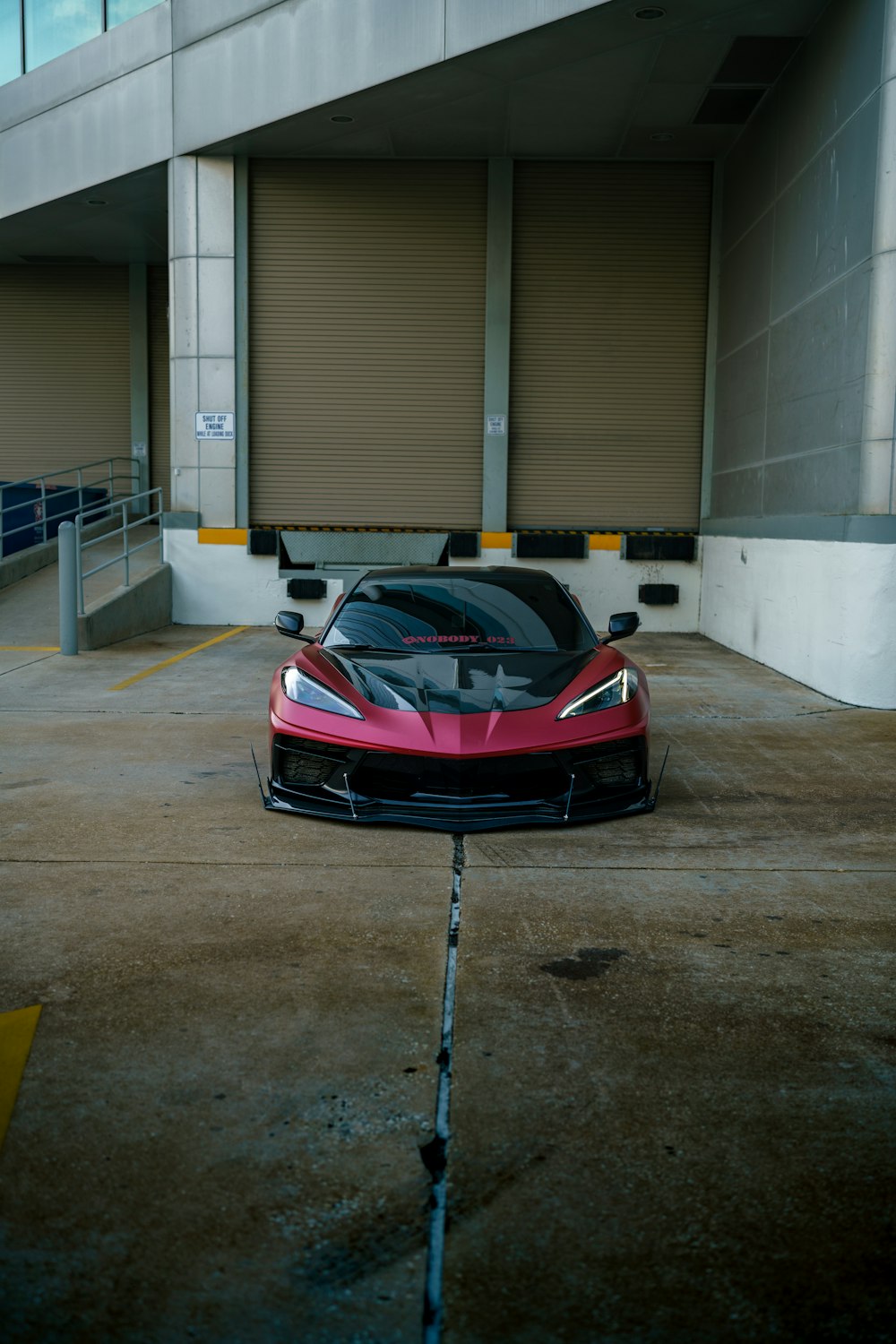 a red sports car parked in a parking lot