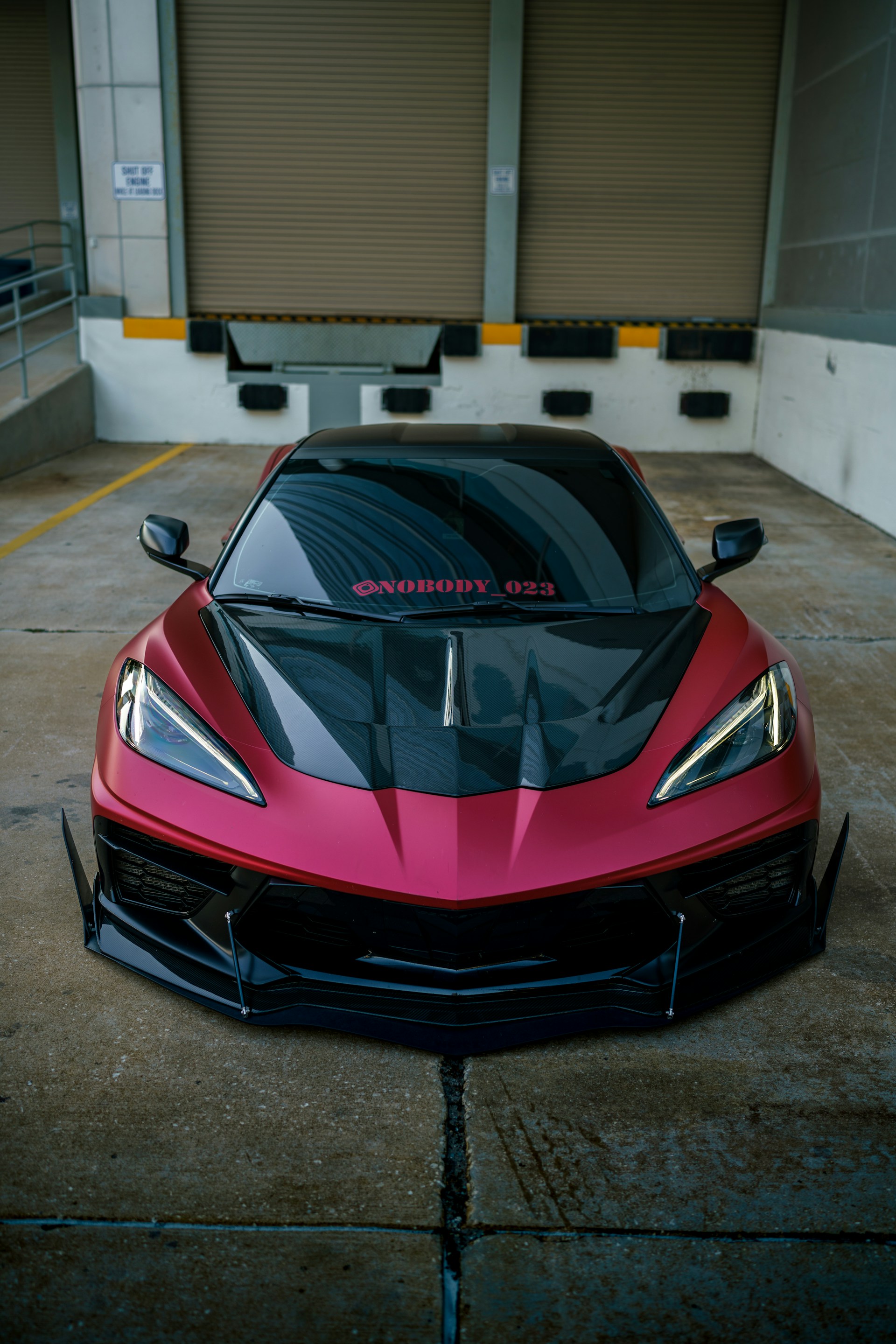 a red sports car parked in a parking lot