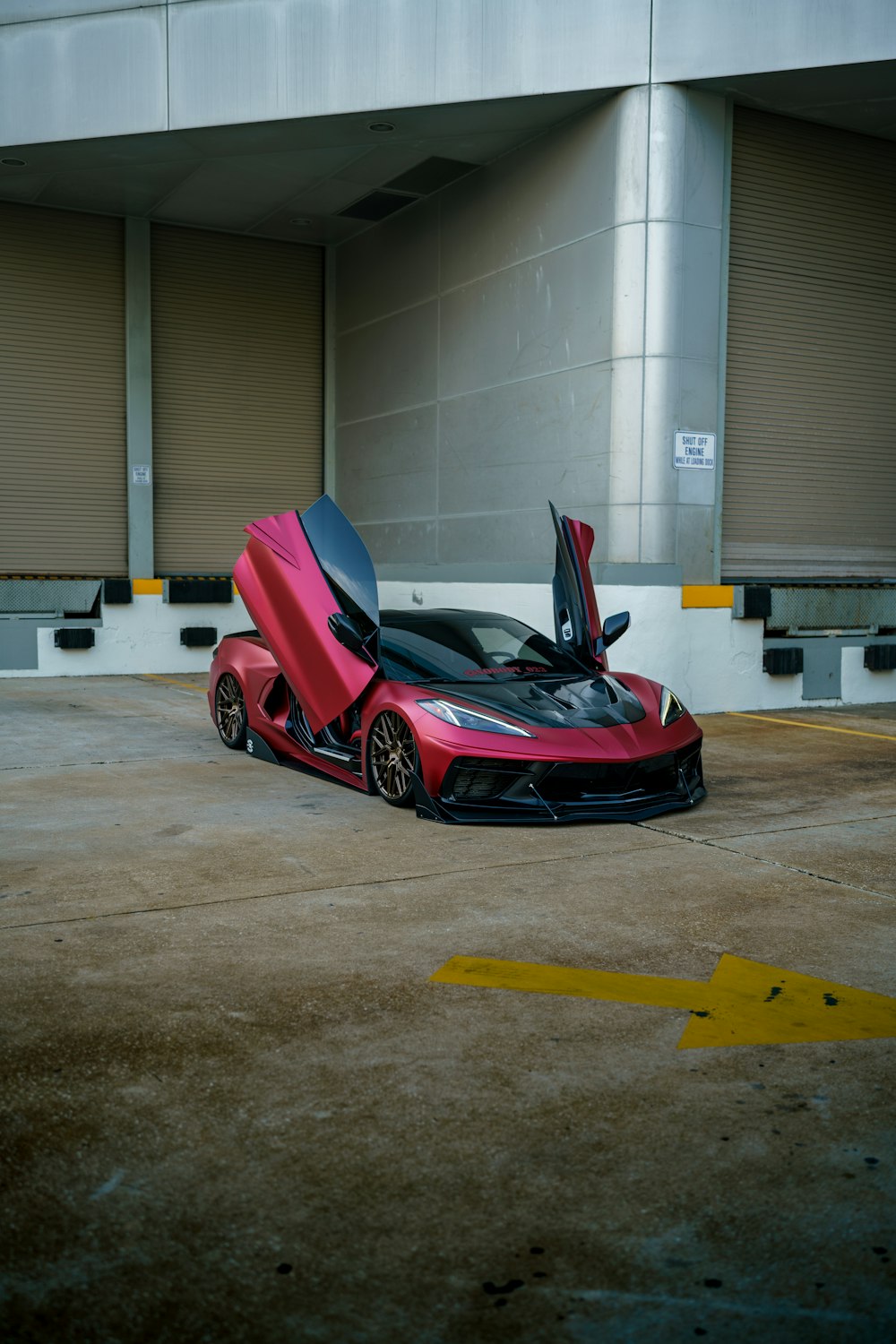 a red sports car parked in a parking lot