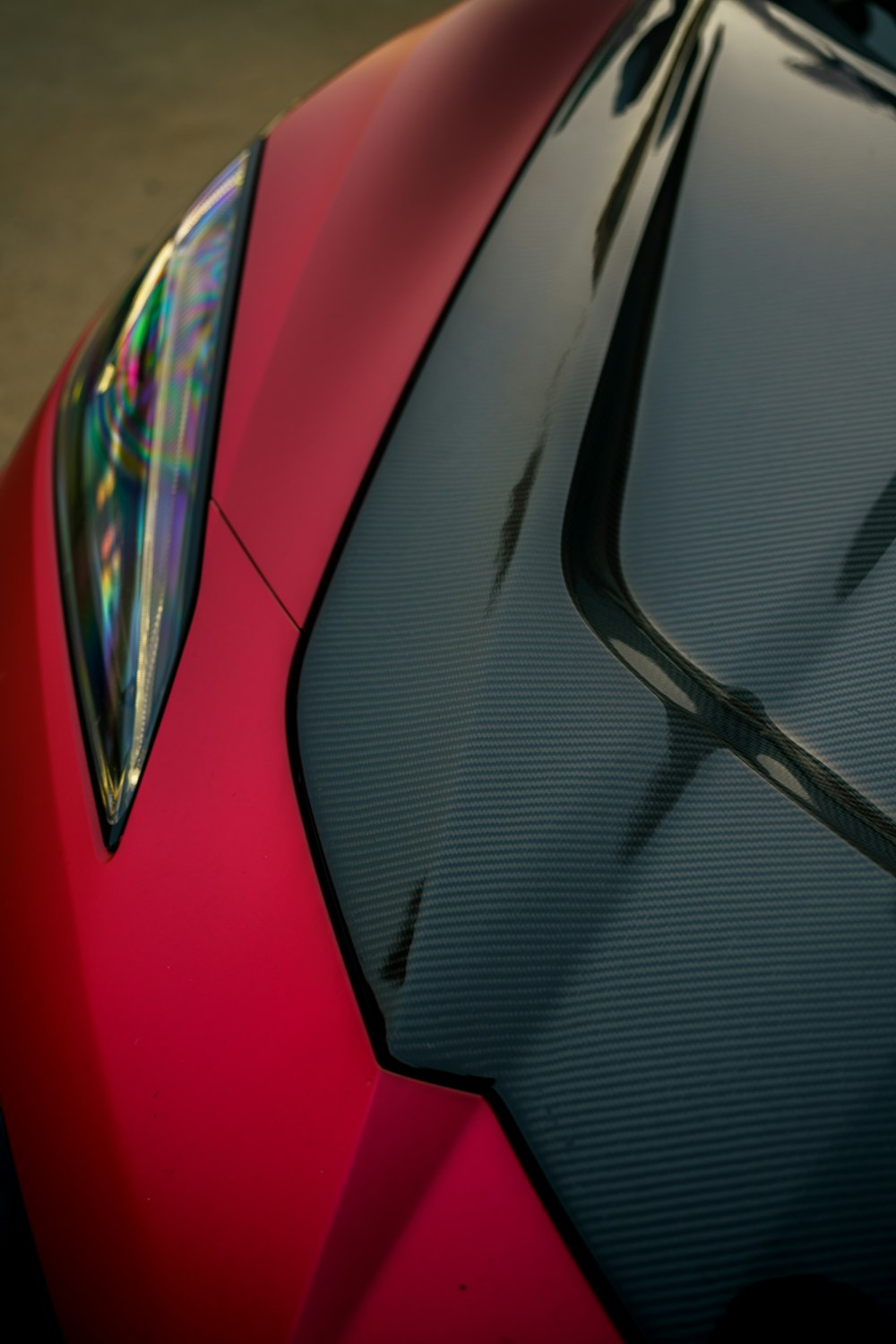 a close up of the hood of a red sports car