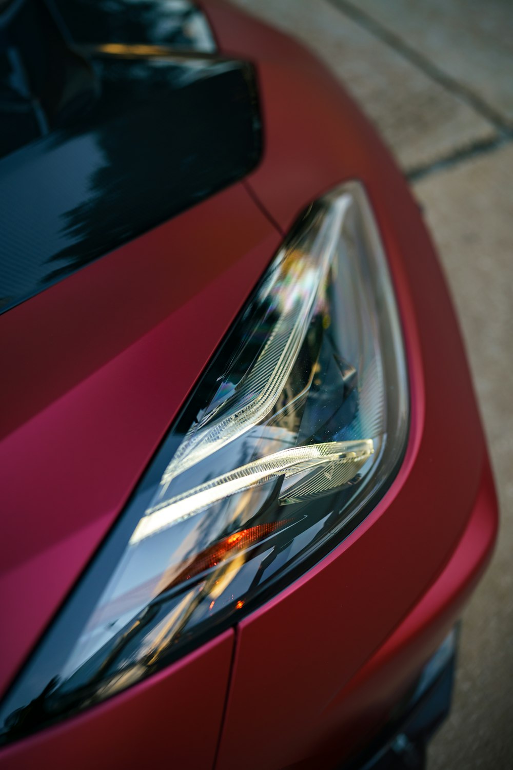a close up of the headlight of a red car
