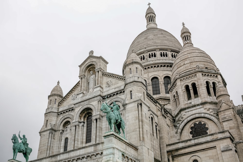 a large building with a statue on the front of it