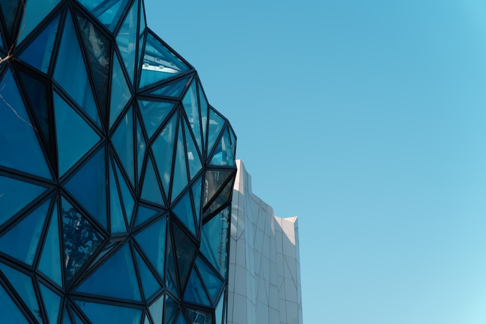 a very tall building with a blue glass facade