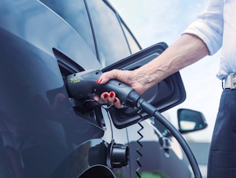 a person pumping gas into a car at a gas station