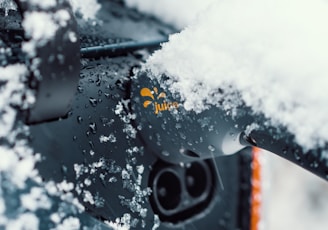 a close up of a car with snow on the windshield