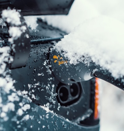 a close up of a car with snow on the windshield