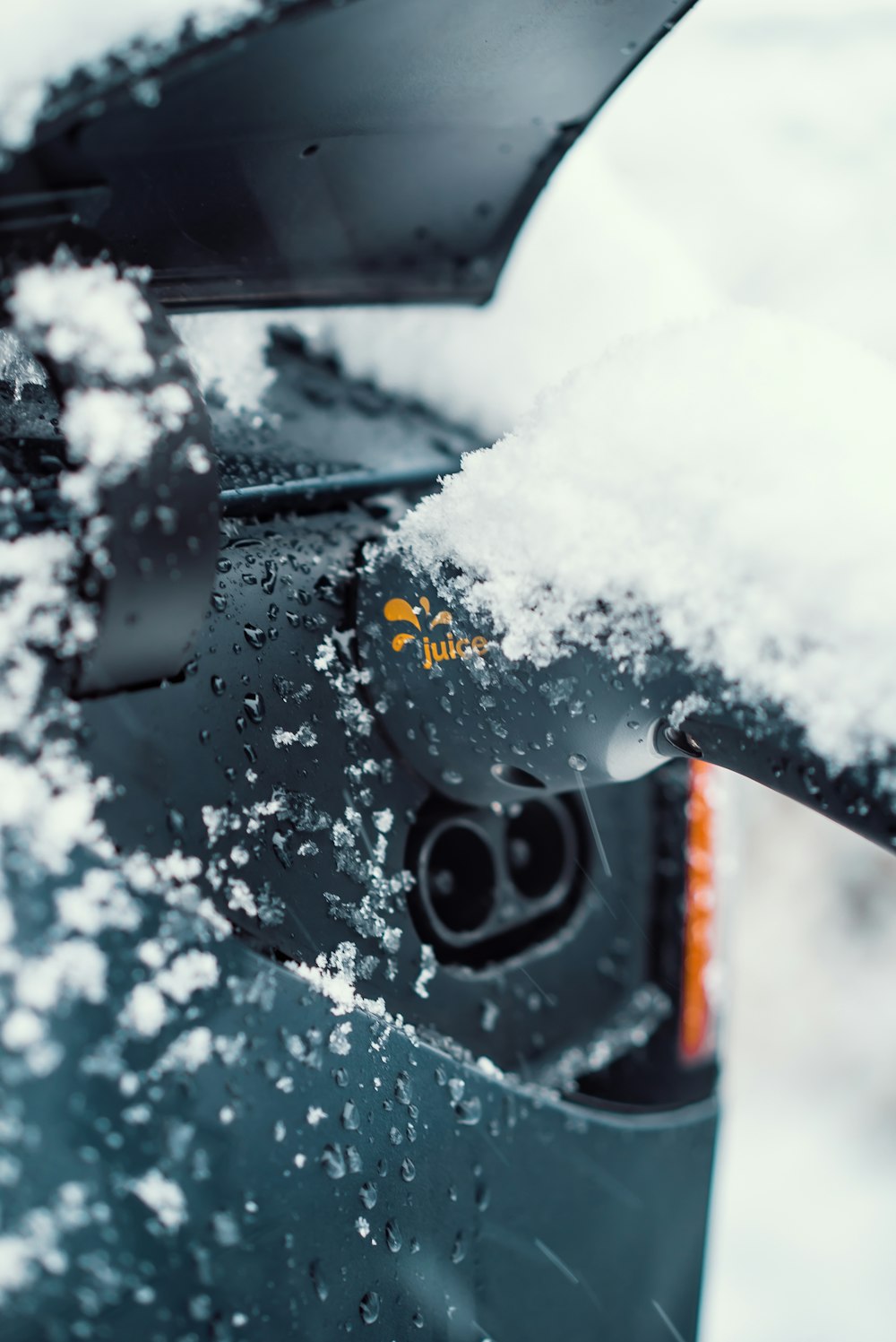 a close up of a car with snow on the windshield