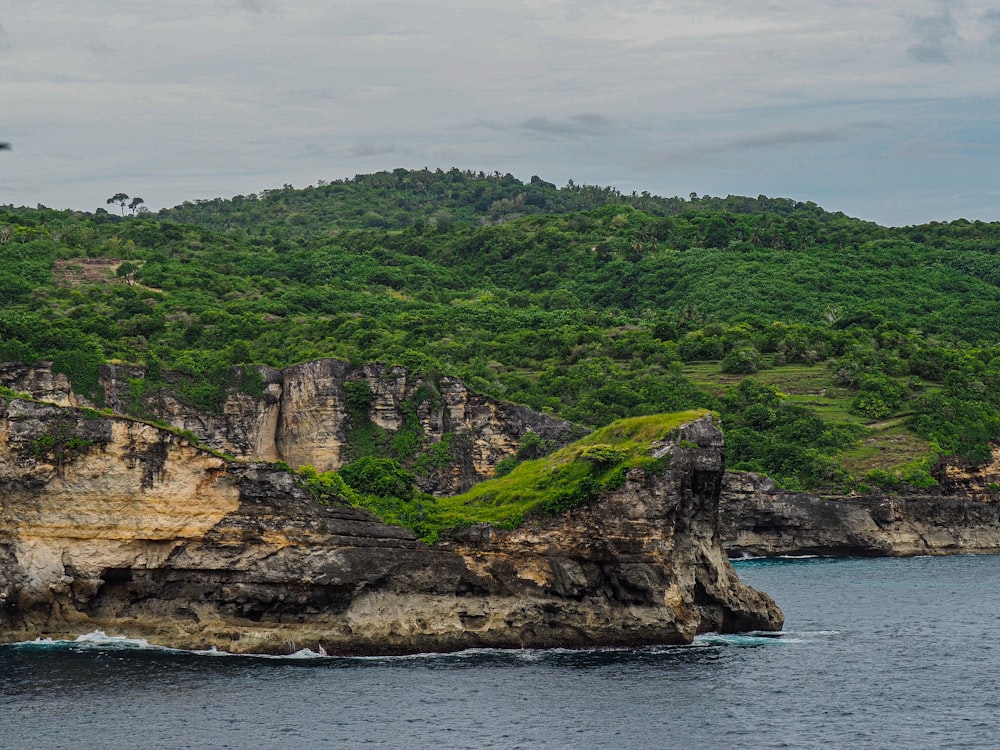 a large rock outcropping in the middle of a body of water