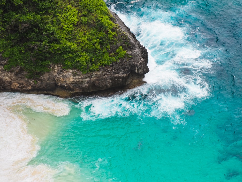 an aerial view of the ocean and a cliff