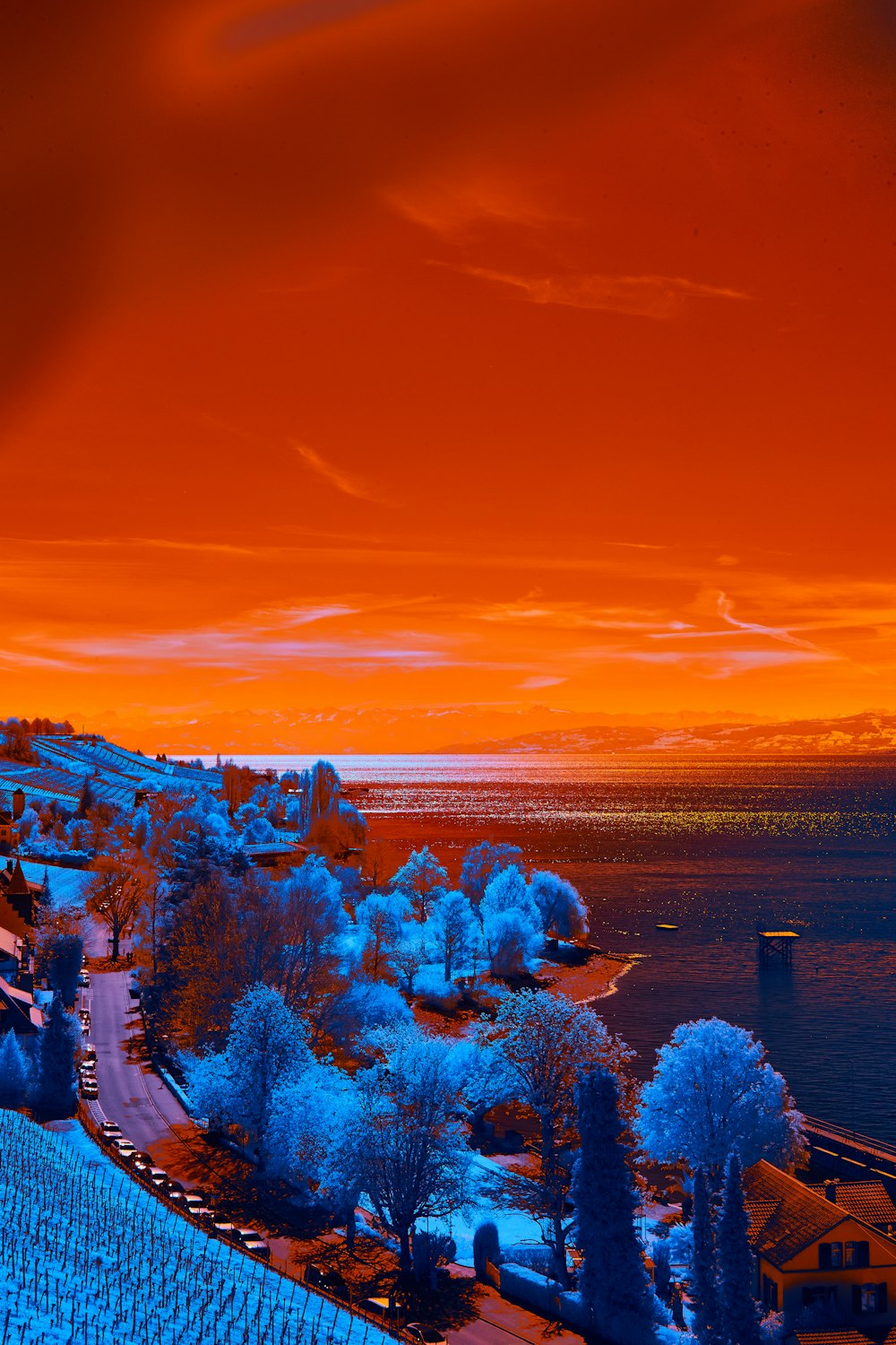 an orange and blue sky over a small town