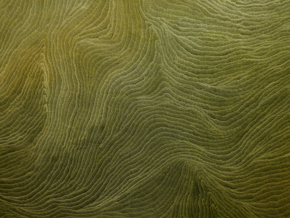 a close up view of a green surface with wavy lines