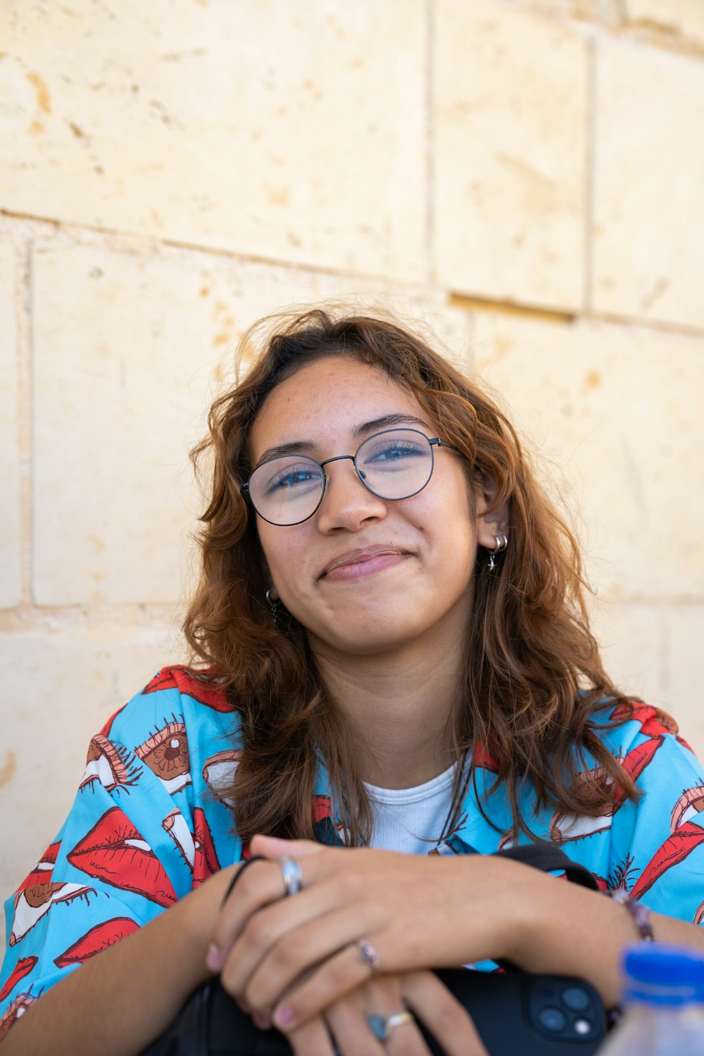 a woman wearing glasses sitting at a table