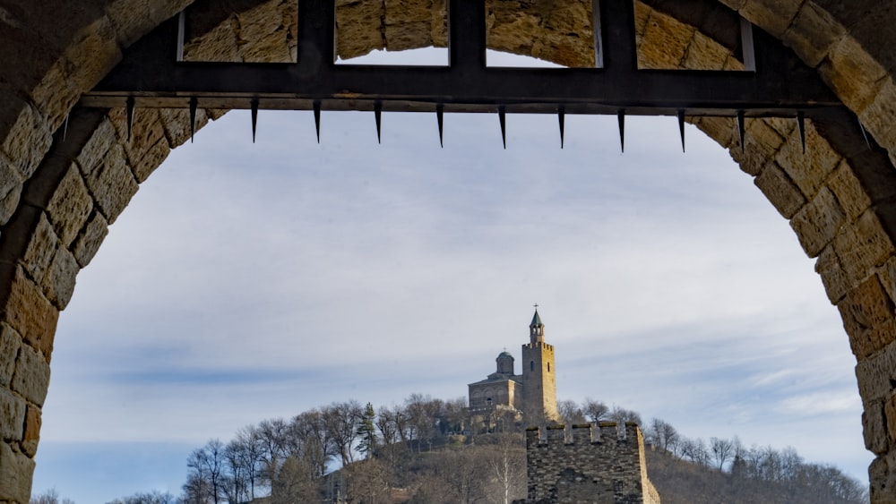 a view of a castle through a stone arch