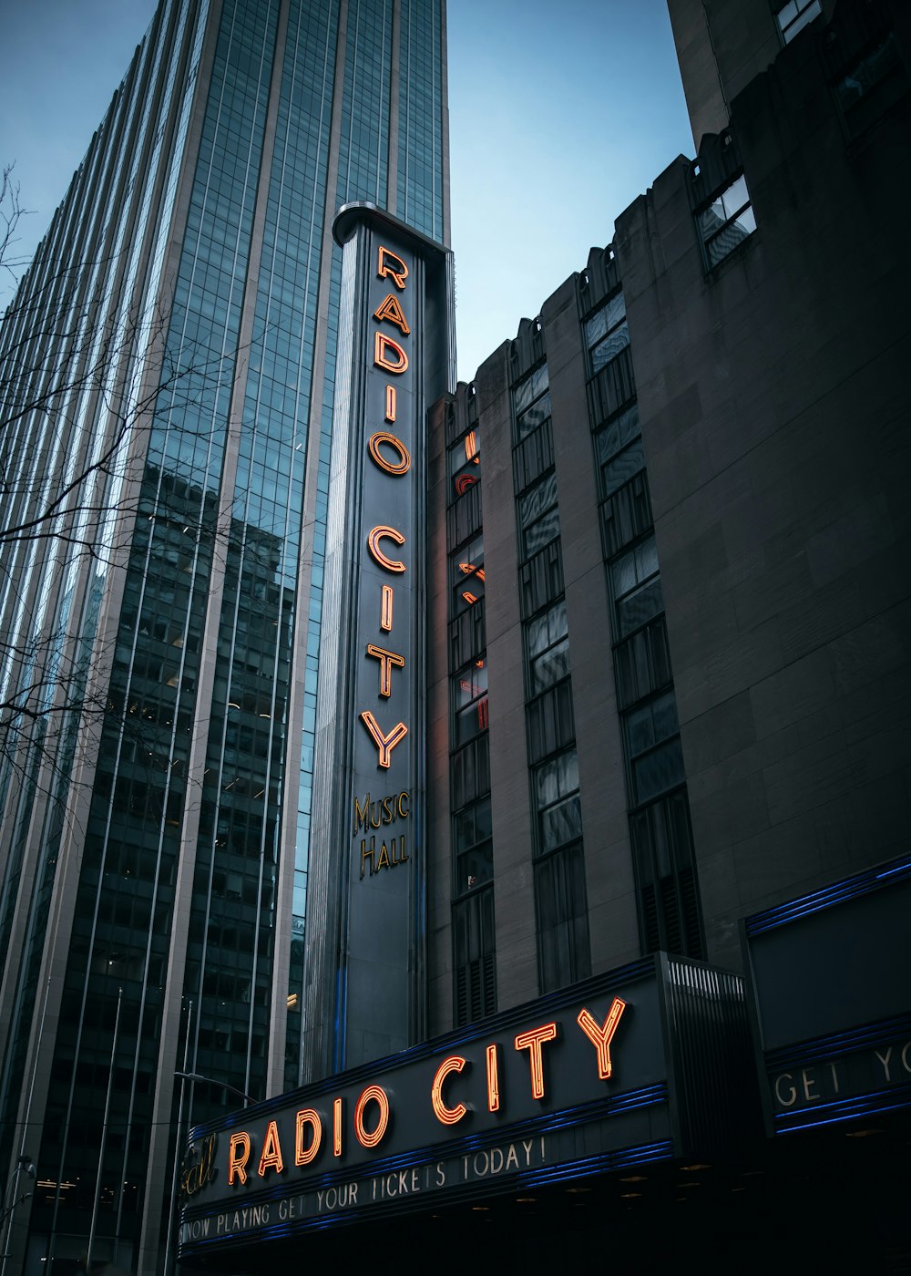 a radio city sign in front of a tall building