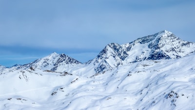 a snow covered mountain with a sky background