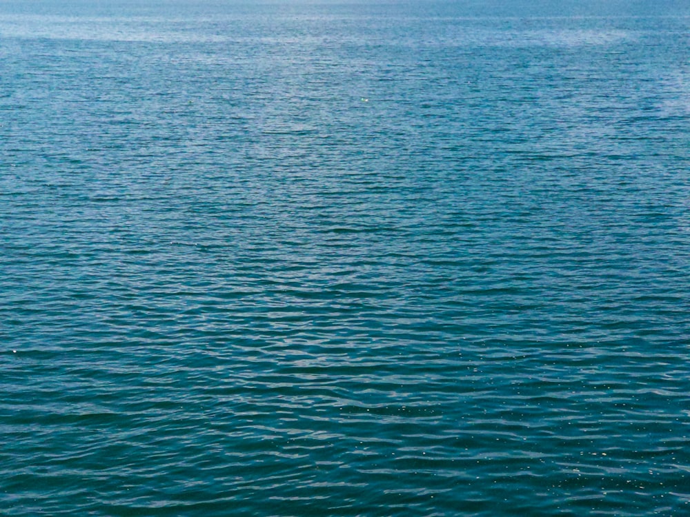 a boat floating on top of a large body of water