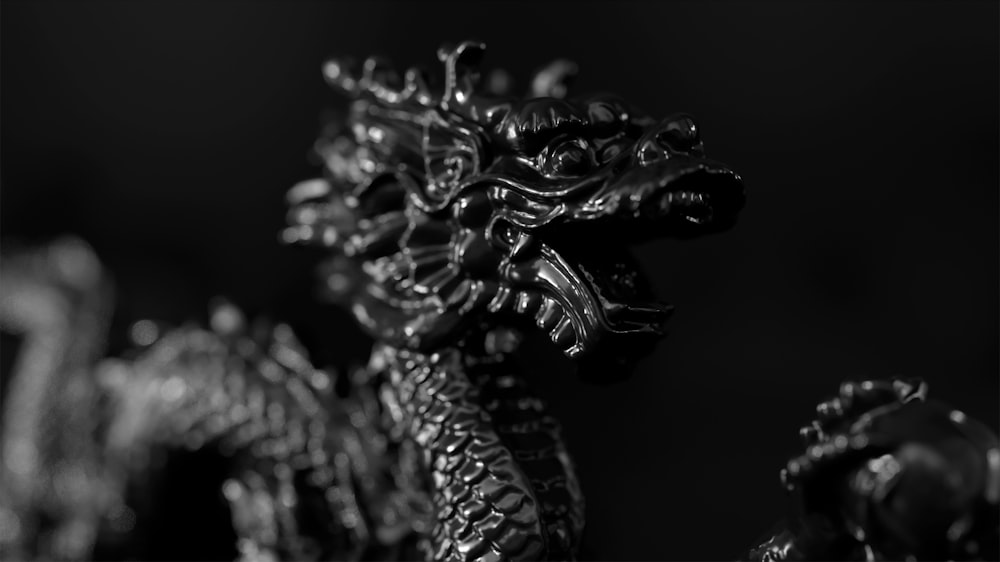 a black and white photo of a dragon statue