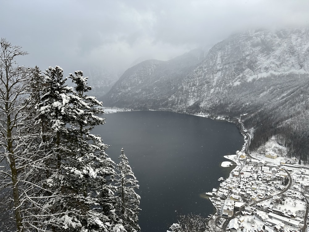 a view of a lake surrounded by snow covered mountains