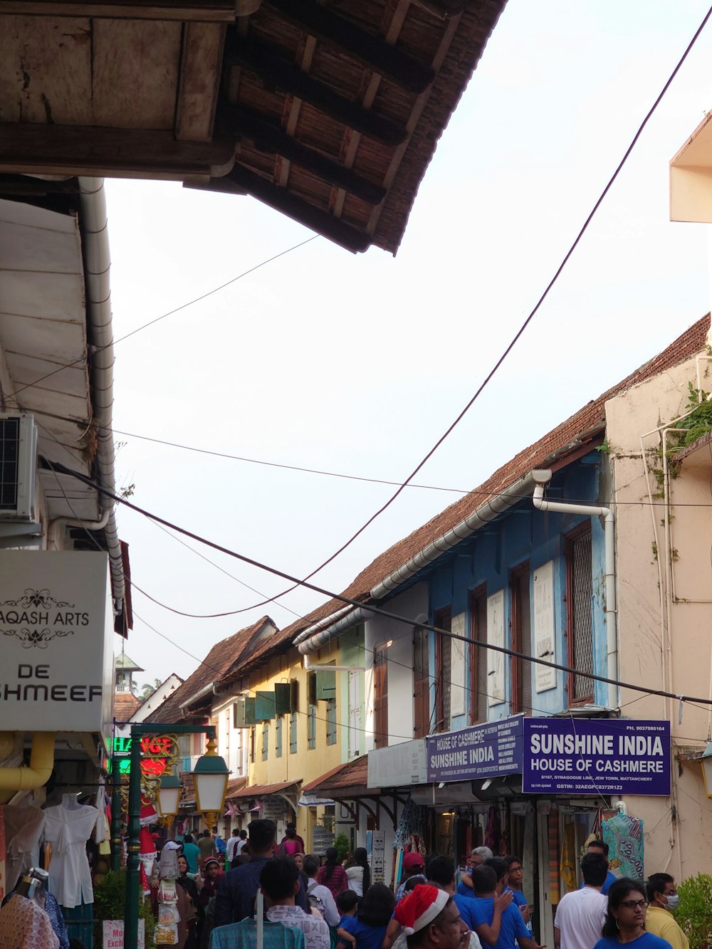 a group of people walking down a street next to buildings