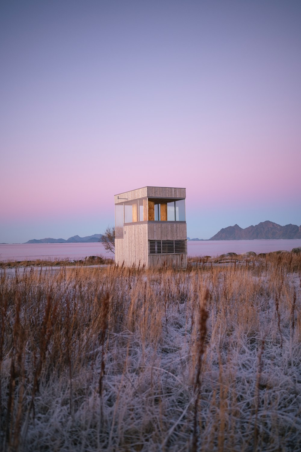 a small building in the middle of a field