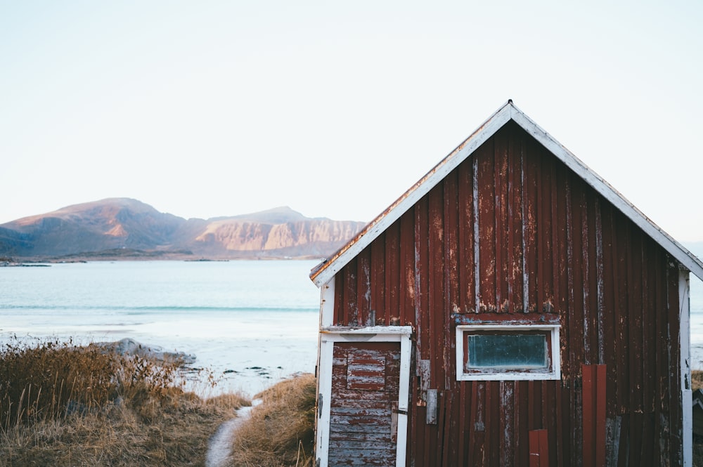 a red building sitting next to a body of water