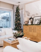 A cozy living room decorated for the holidays with a scrapbook on a table.