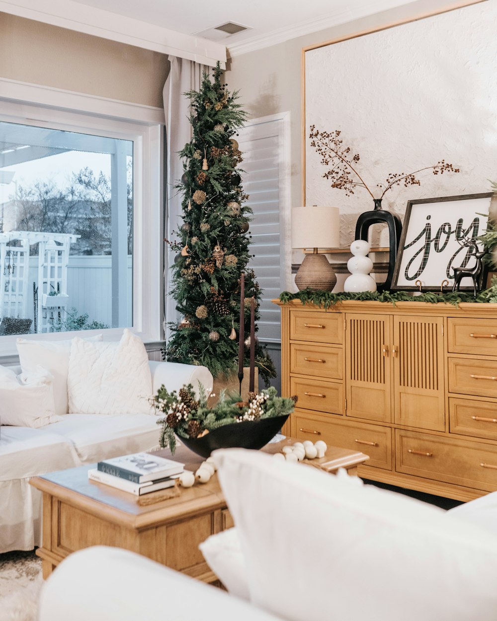 a living room filled with furniture and a christmas tree