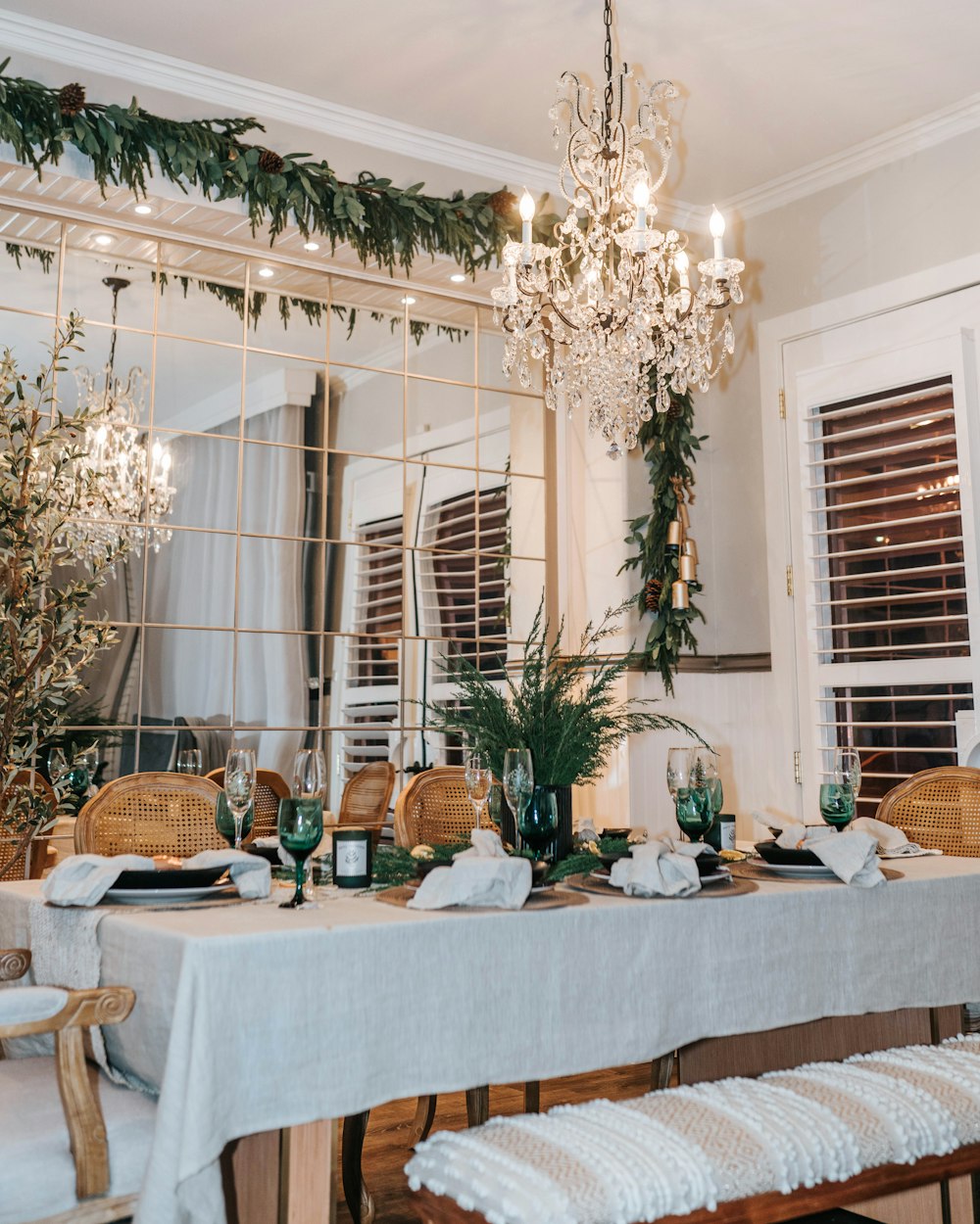 a dining room table with a chandelier hanging from the ceiling