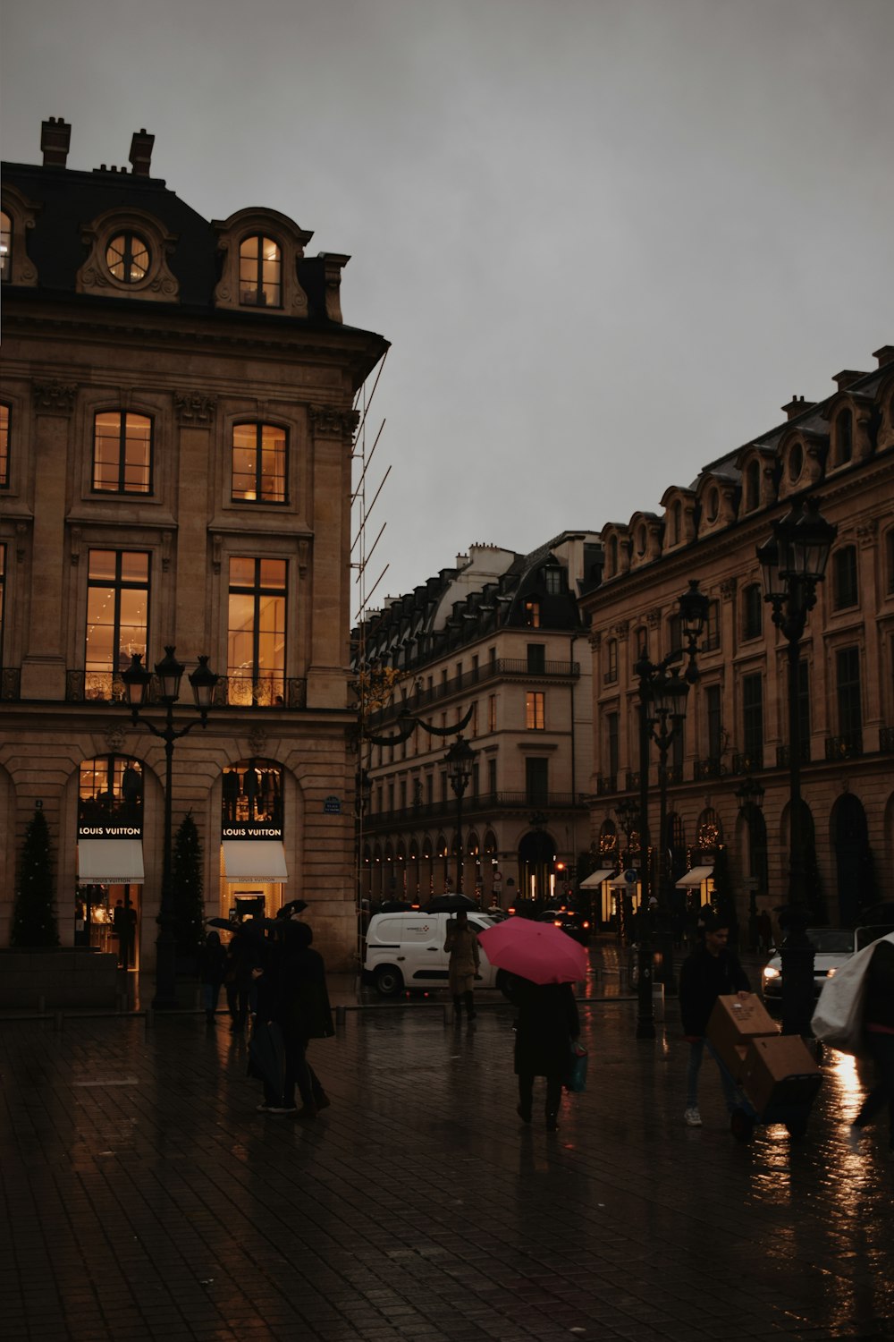 a group of people walking down a street holding umbrellas