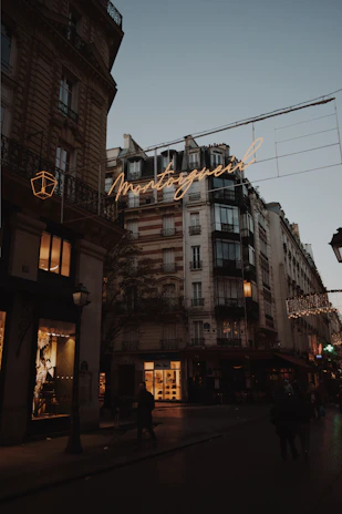Wide shot of a Parisian street scene bathed in warm afternoon light, capturing creative inspiration.