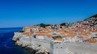 Panoramic view of Zadar’s old town rooftops with the shimmering sea beyond at sunrise.