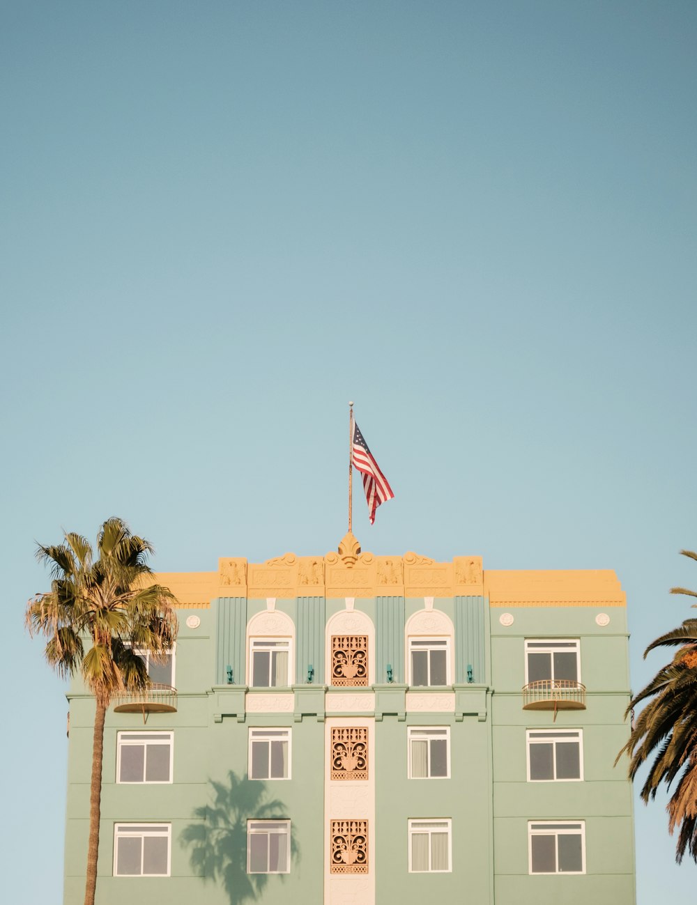 a tall building with a flag on top of it