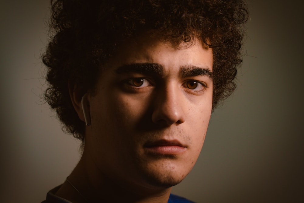 a close up of a person with curly hair