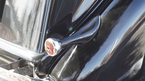 Close-up of a shiny, freshly detailed car exterior reflecting sunlight.