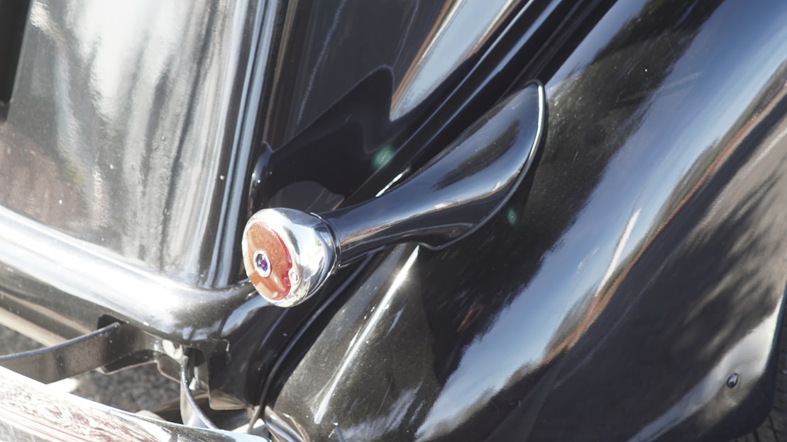 Close-up of a sleek car with a vibrant vinyl wrap reflecting sunlight