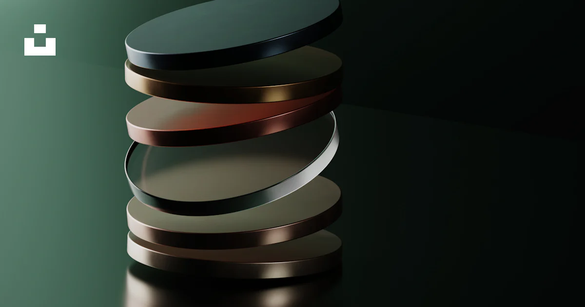 Metal Disc Stack A stack of metal discs sitting on top of a table photo – Free Webdesign ...