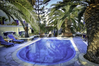 A friendly consultant discussing aquatic project plans with a client by a poolside