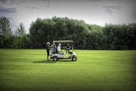 A group of golfers enjoying a ride in an electric cart.
