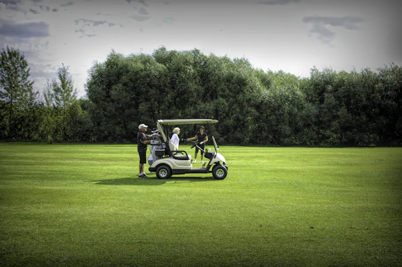 Friendly staff helping customers at Thoroughbred Golf Carts dealership in Englewood, FL.