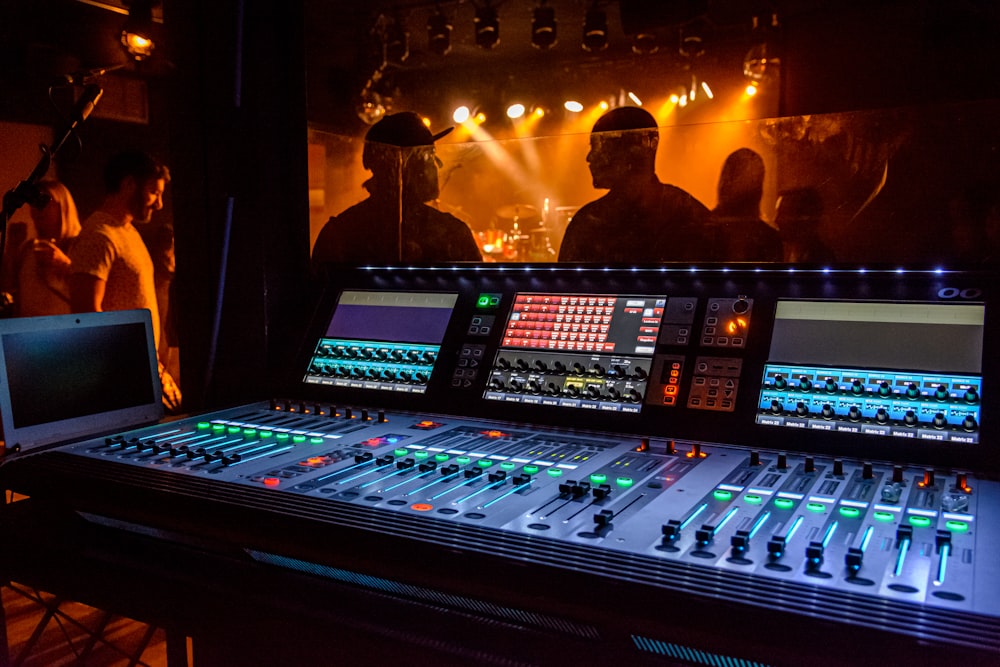 a mixing desk with a laptop on top of it