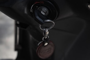 Close-up of a locksmith programming a car key with specialized equipment.